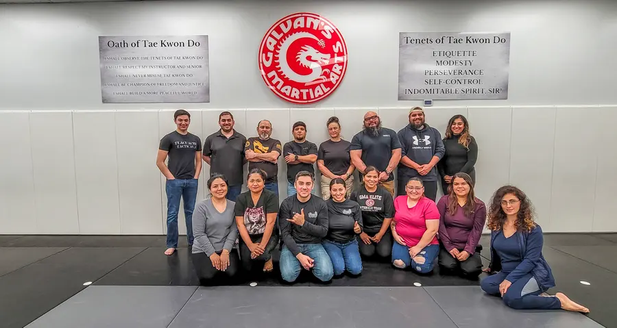 A full class of Firearms Academy students posing together at the end of a course in Brownsville