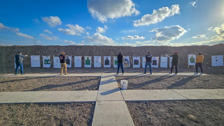Students on the firing line at an outdoor range near Brownsville, shooting at silhouette targets